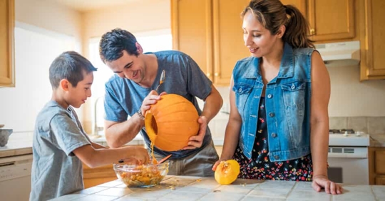Family carving pumpkins.