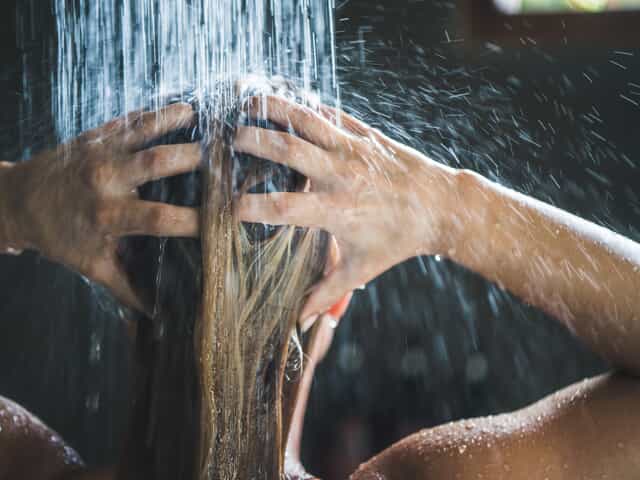 Woman taking a hot shower. 