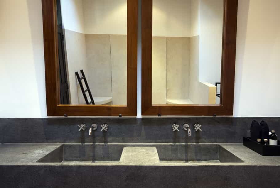 Bathroom counter with a cement sink. 